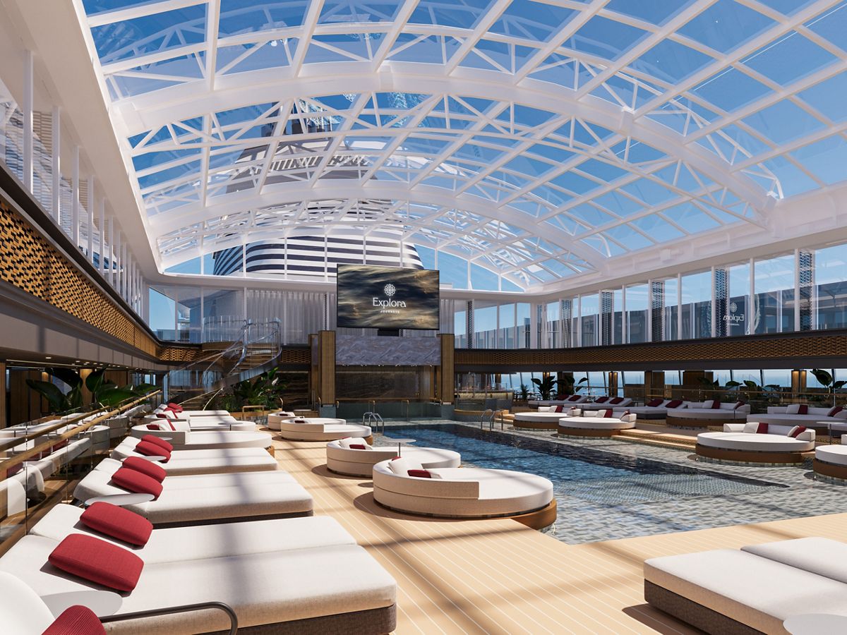 Sunbeds around the Conservatory pool under a glass roof aboard Explora Journeys