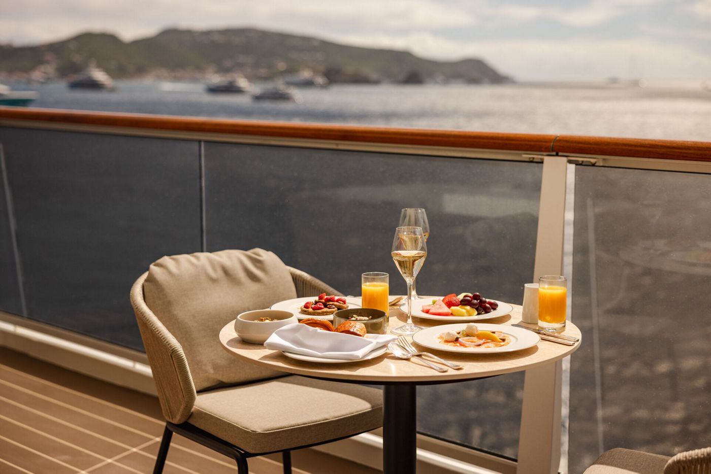 Breakfast laid out on a private suite terrace aboard an Explora Journeys ship, with the sea beyond