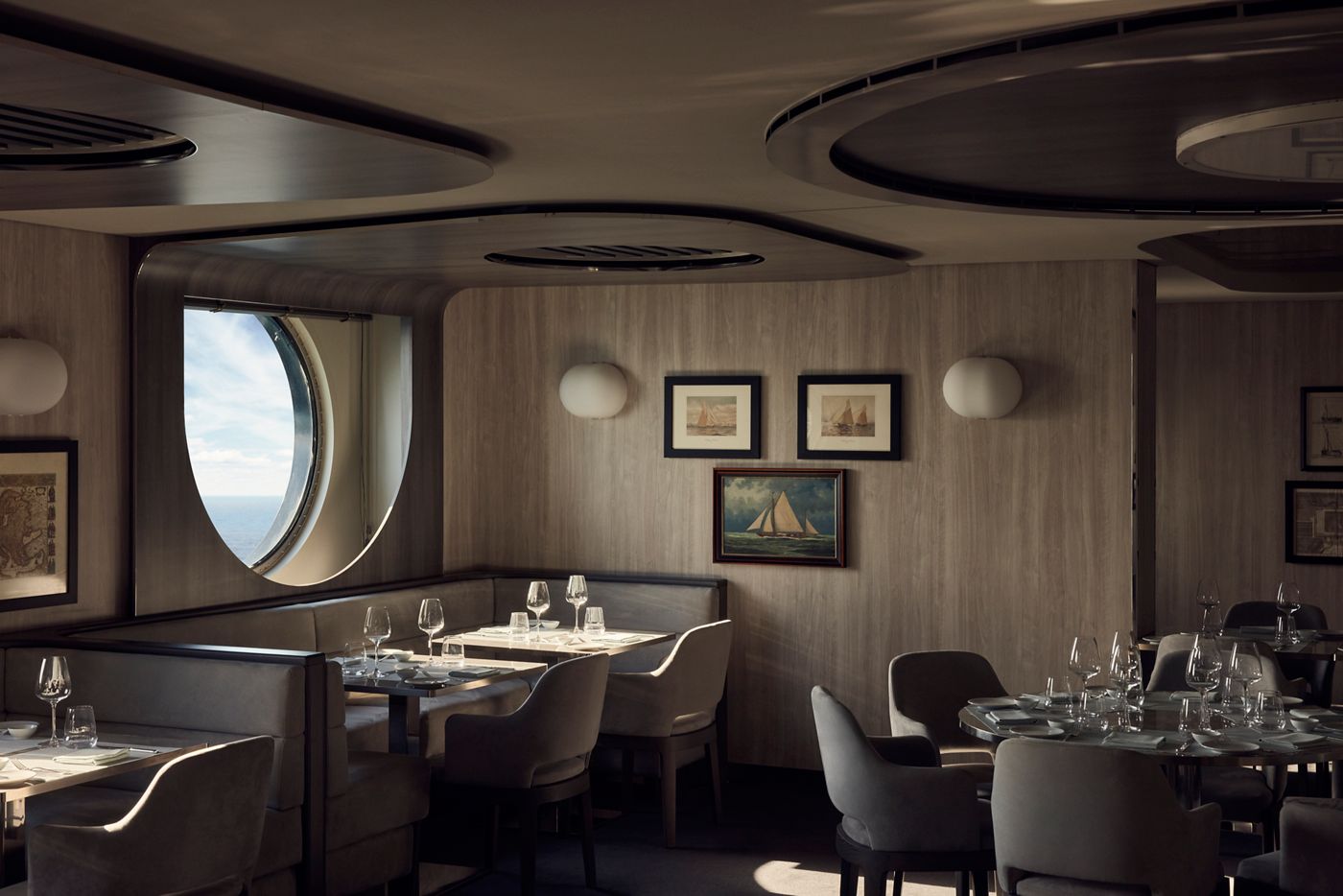 Tables laid for dinner at Med Yacht Club aboard Explora Journeys